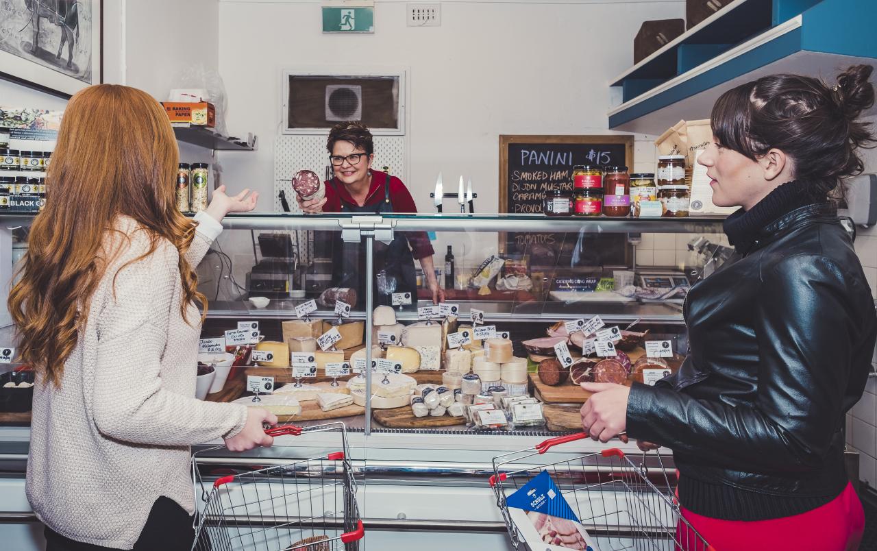 Two women being served at local delicatessen