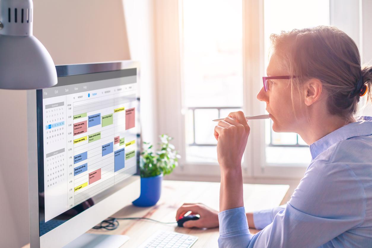 Woman reading calendar on computer screen