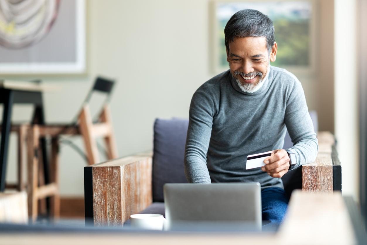 Man using laptop and making credit card payment online