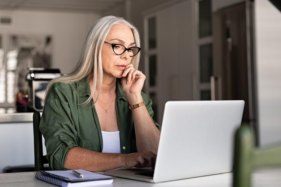 Concerned woman looking at computer screen