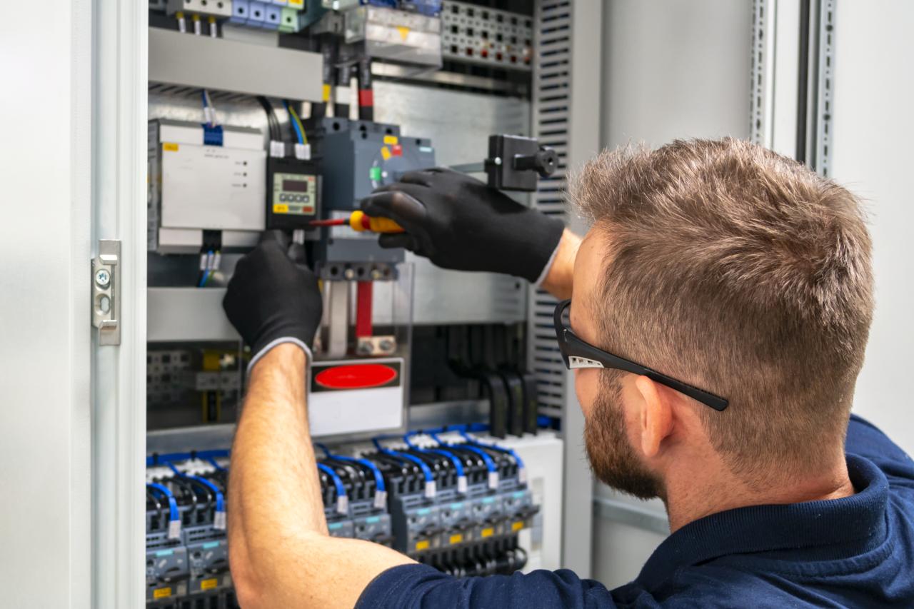 man repairing circuit board