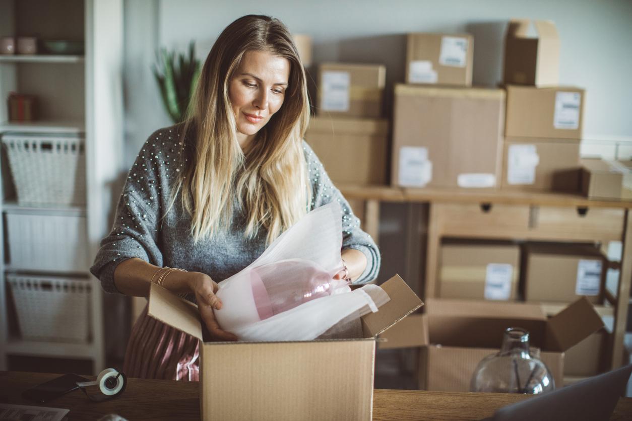 Woman packs cardboard box