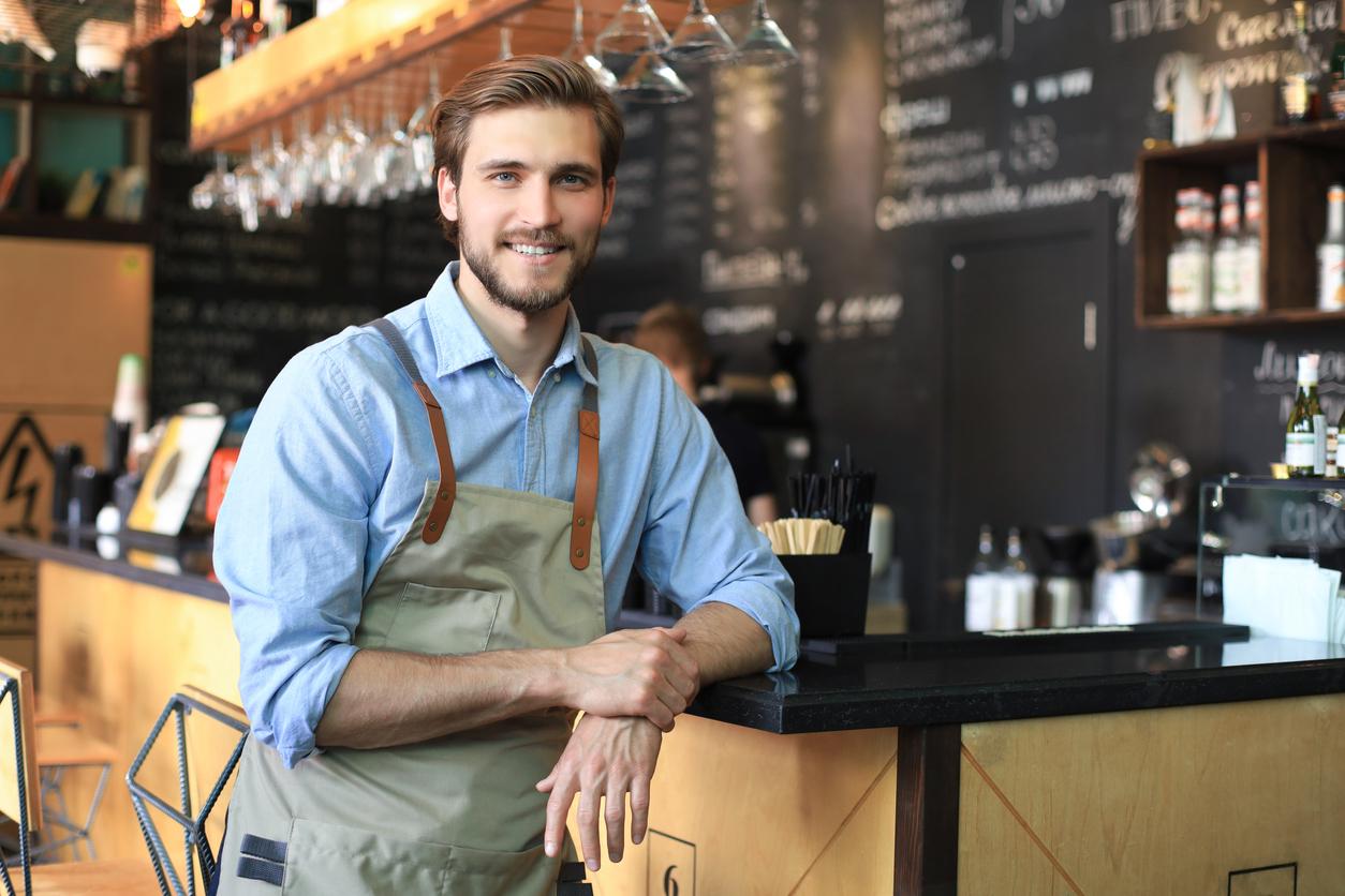 Young man standing near bar