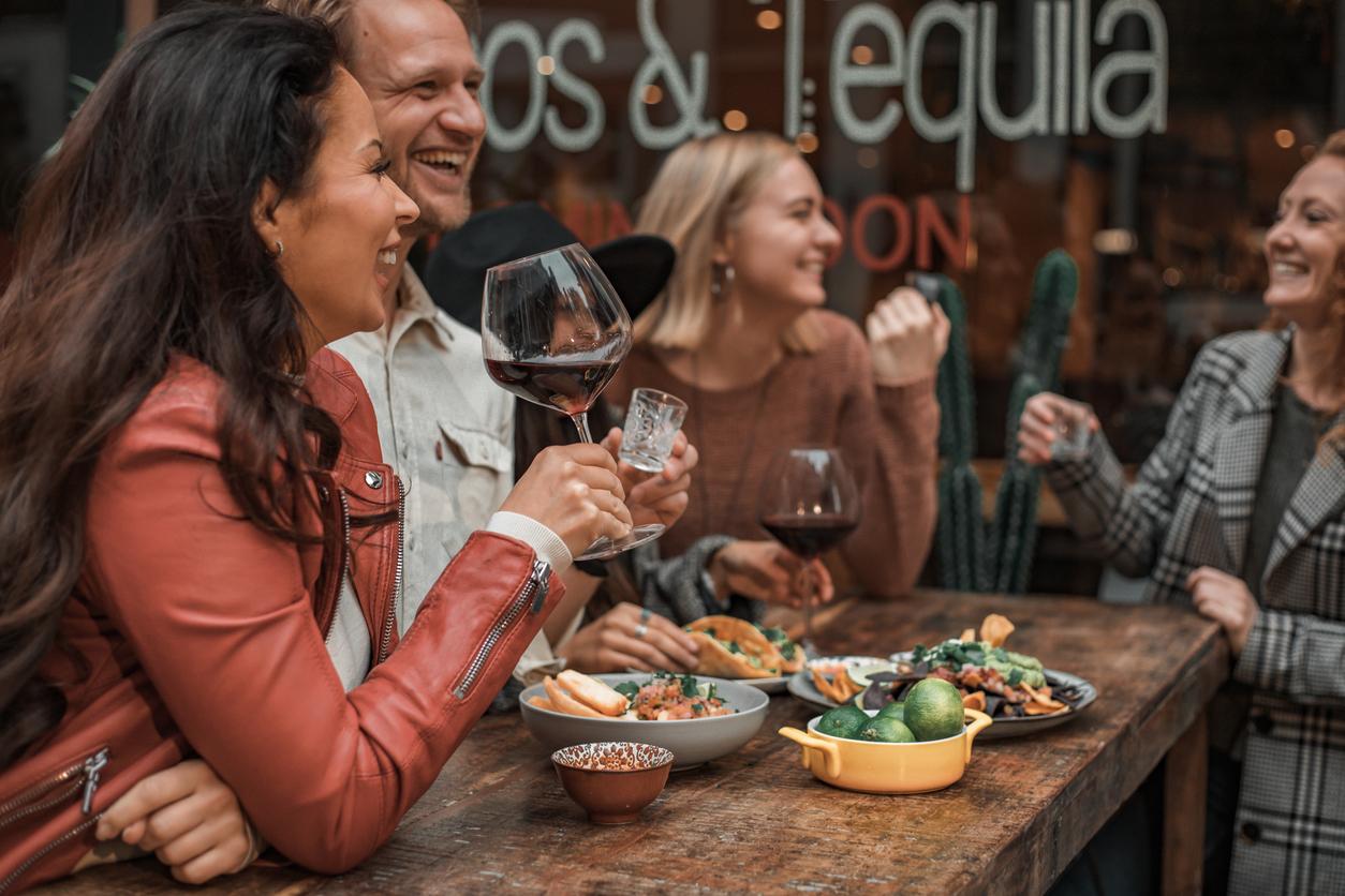 People sitting around a table talking and eating