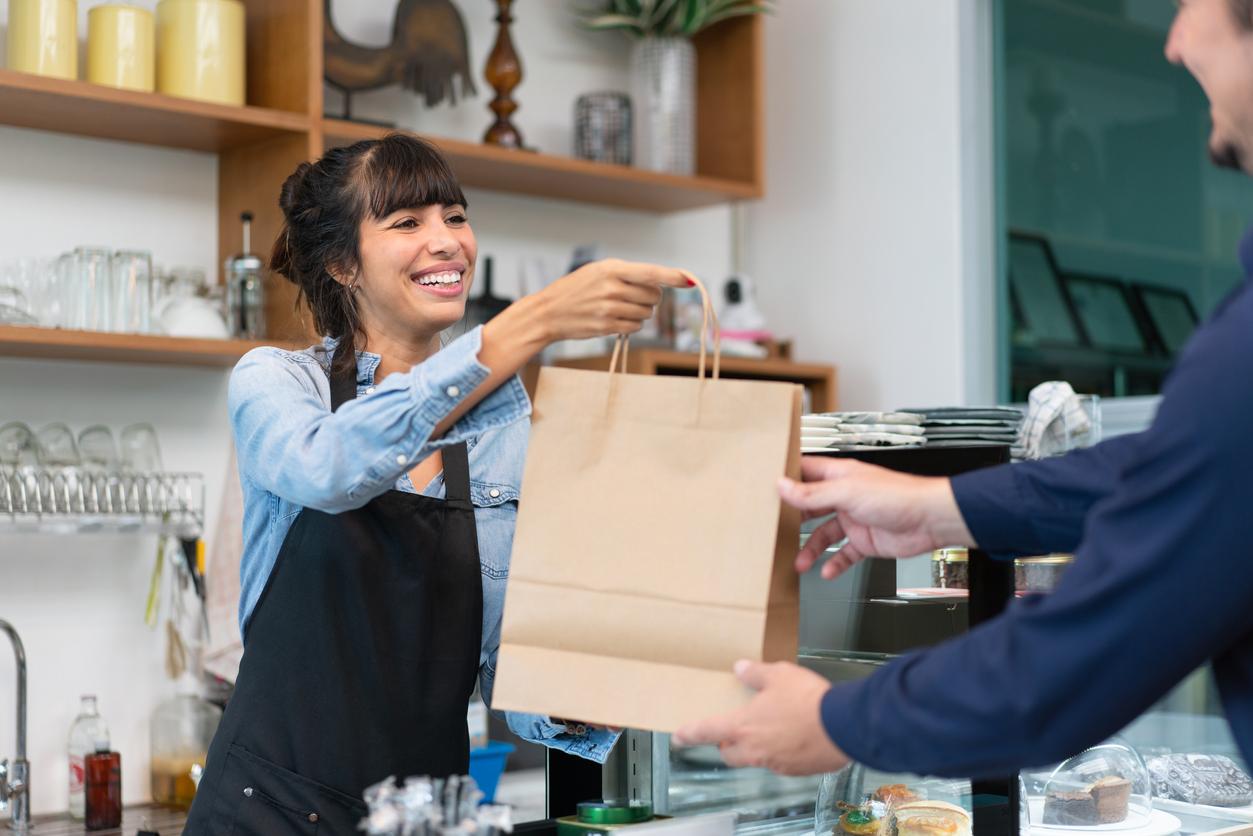 Woman hands over paper bag