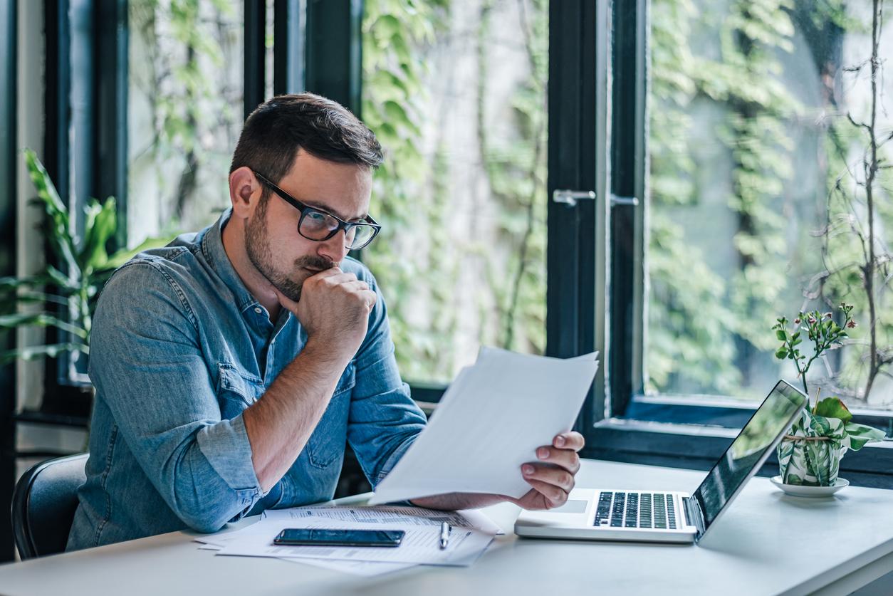 Concerned man looking at papers