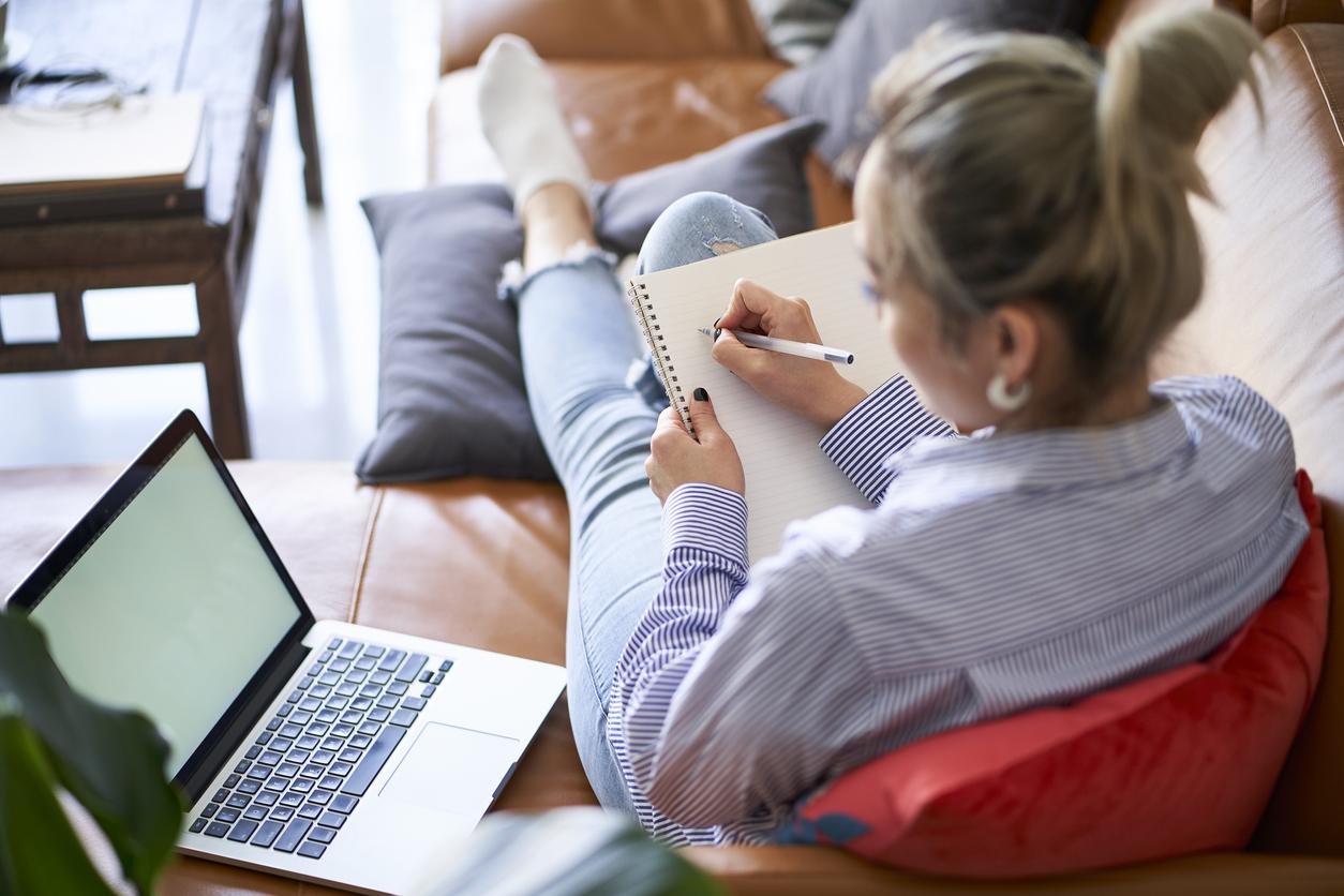 Woman on couch with laptop