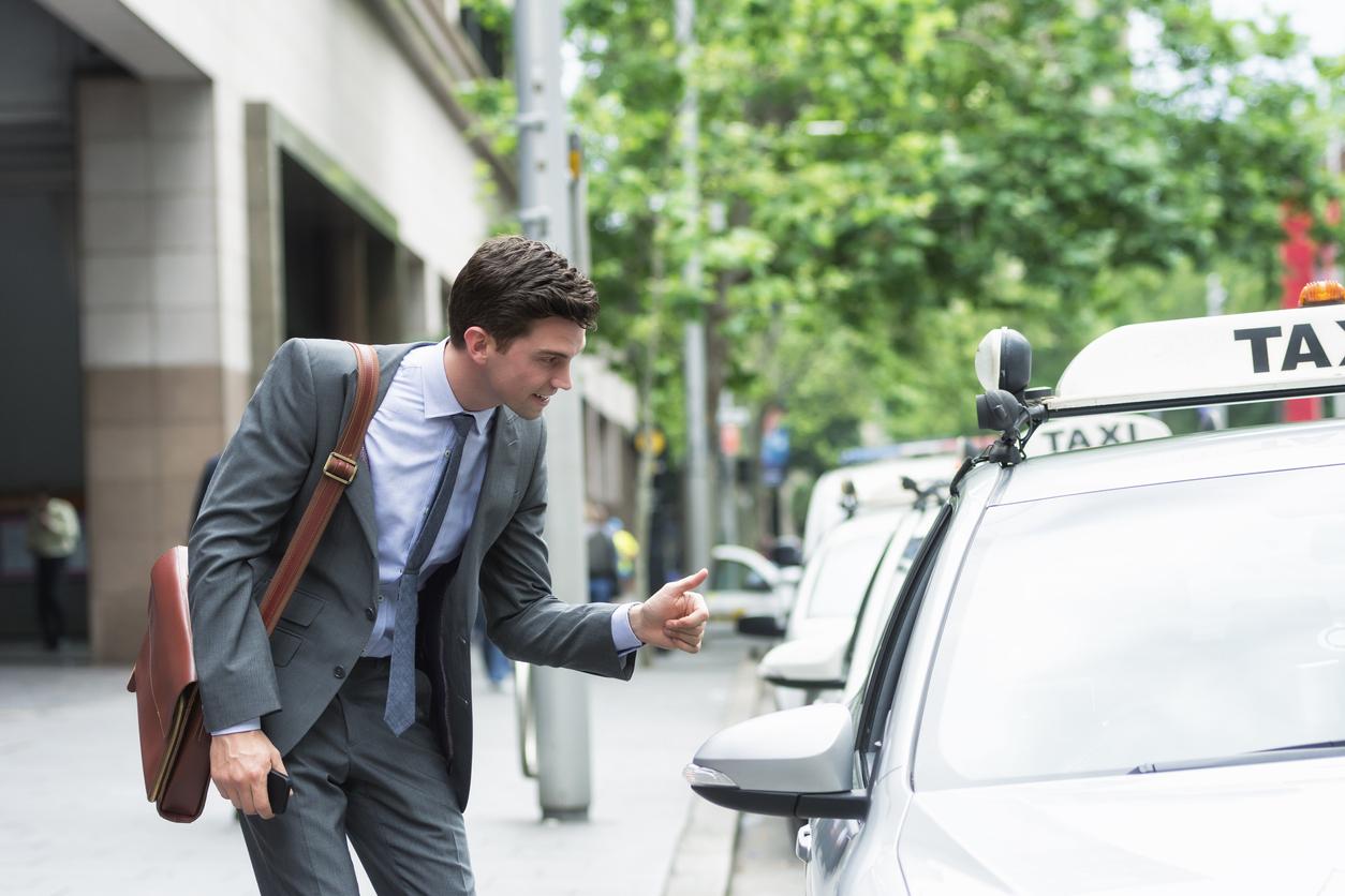 Man talking to taxi driver