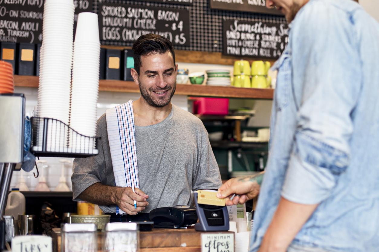 Man at cafe serves customer