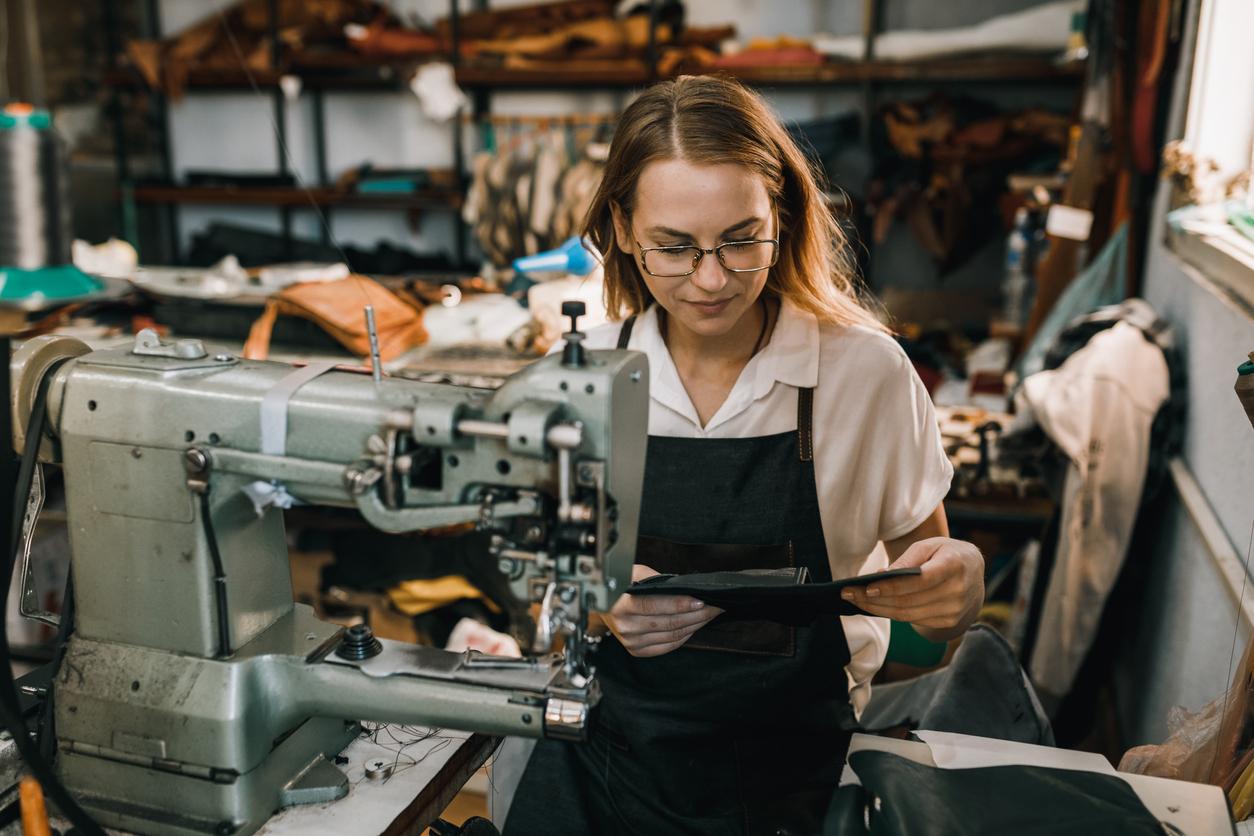 young woman using sewing machine