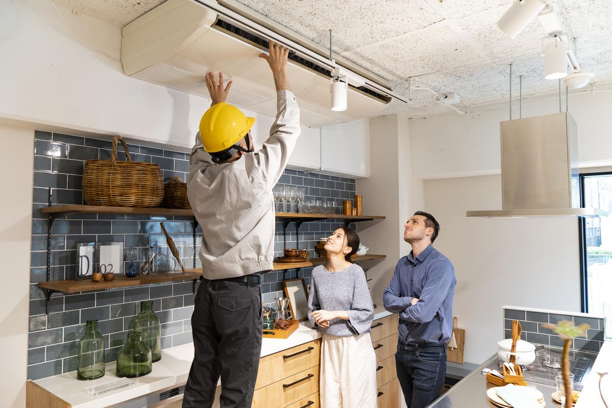 A repairman checking the air conditioner