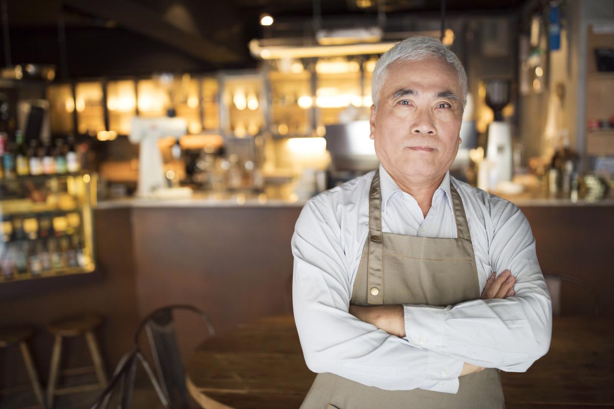 Man standing in front of bar