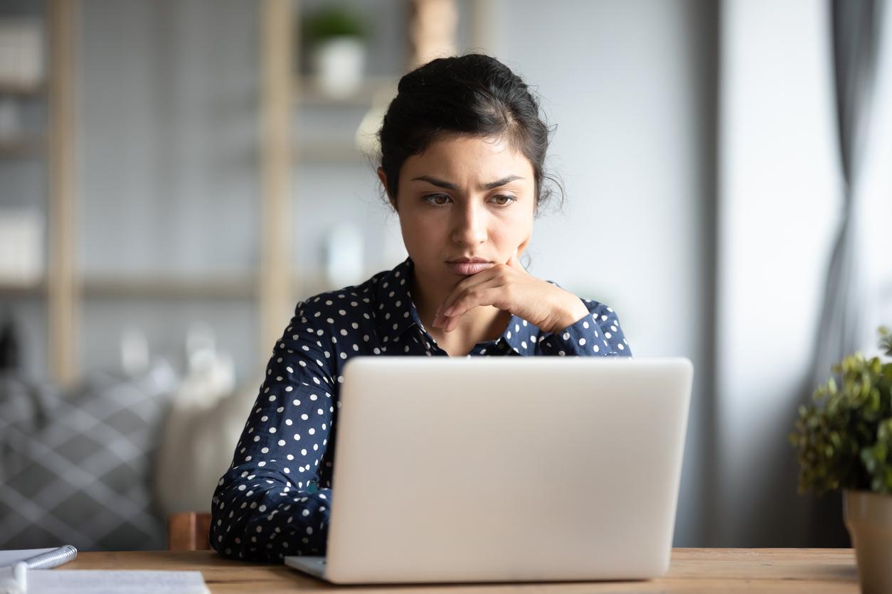 Worried woman looking at computer