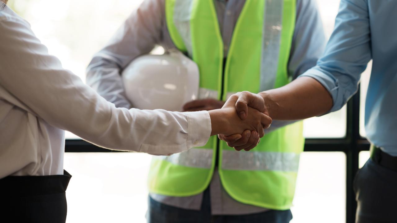 Construction workers shaking hands