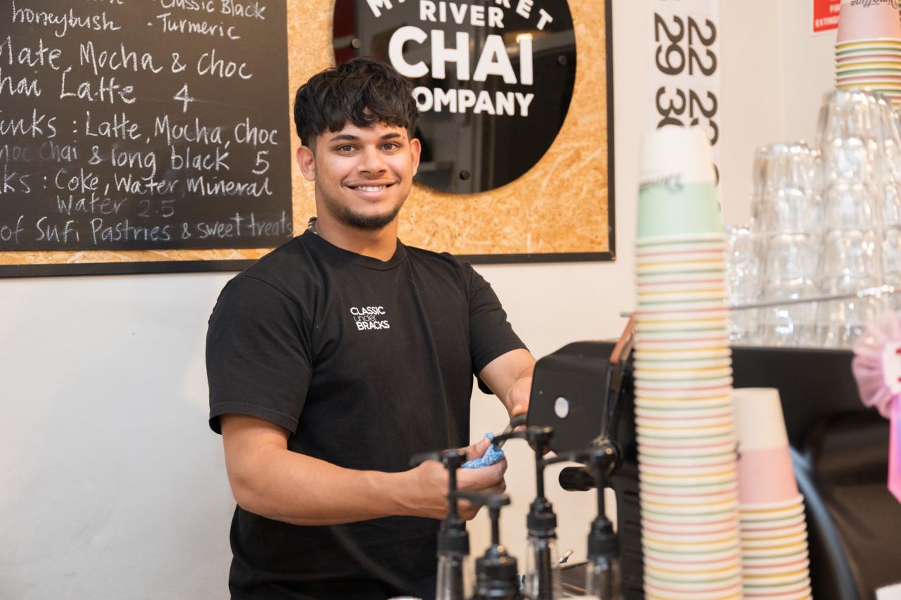 Man smiling making coffee