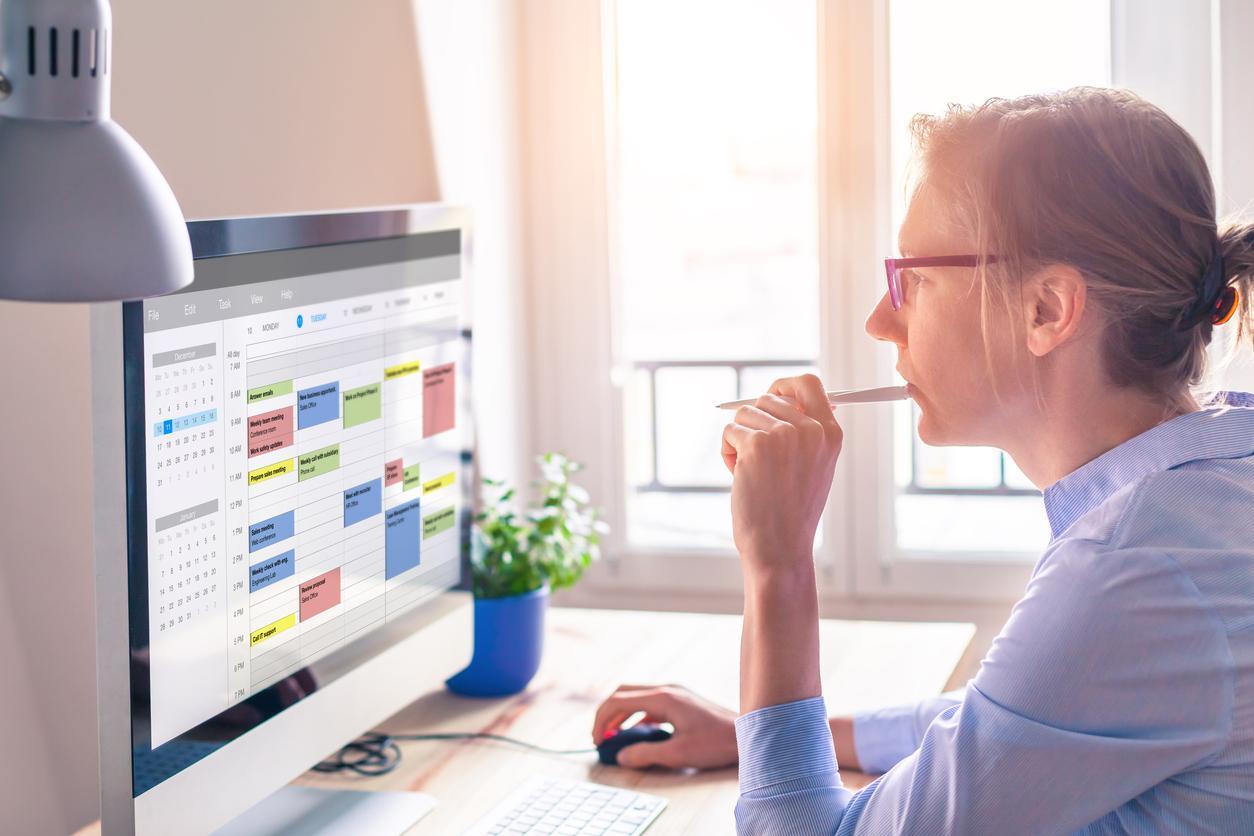 Woman looking at calendar on computer screen