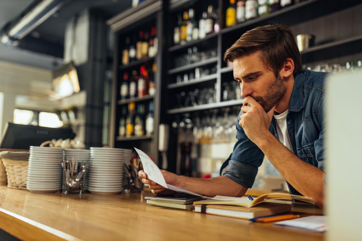 Worried man looking at documents