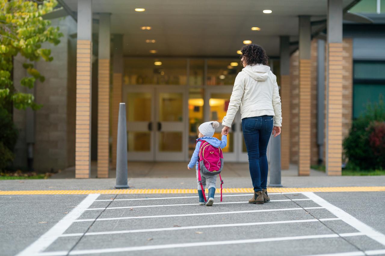 Mom dropping toddler daughter off at school